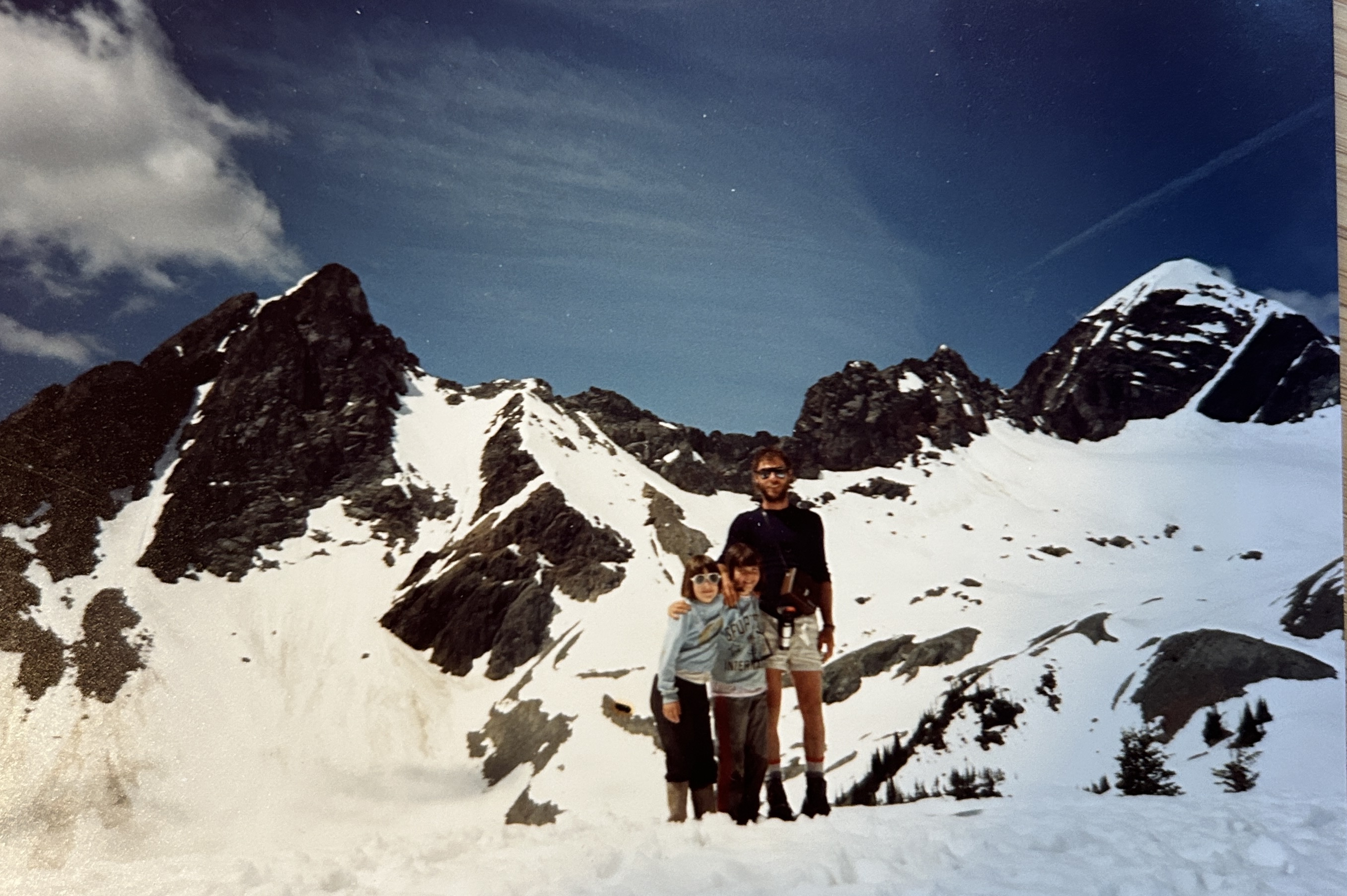 Father and daughters in the mountains.